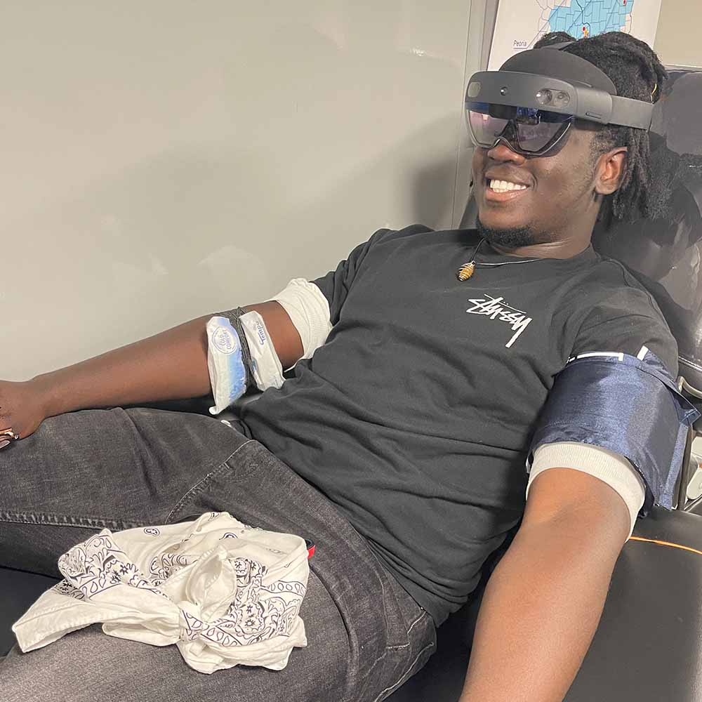 Donor wearing Abbott mixed reality headset during ImpactLife blood drive