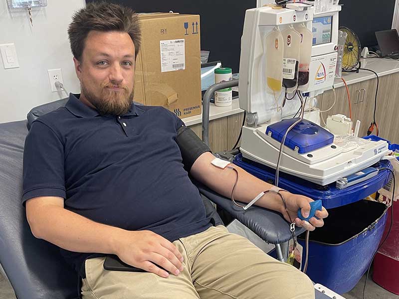 Man reclining and donating blood during the ImpactLife Blood Drive in Ottumwa, Iowa at Southeast Iowa Sports Center