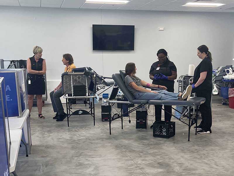 Staff member preparing a donor for donation at the ImpactLife Blood Drive in Ottumwa, Iowa at Southeast Iowa Sports Center